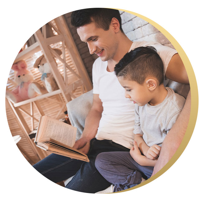 man and toddler reading a book