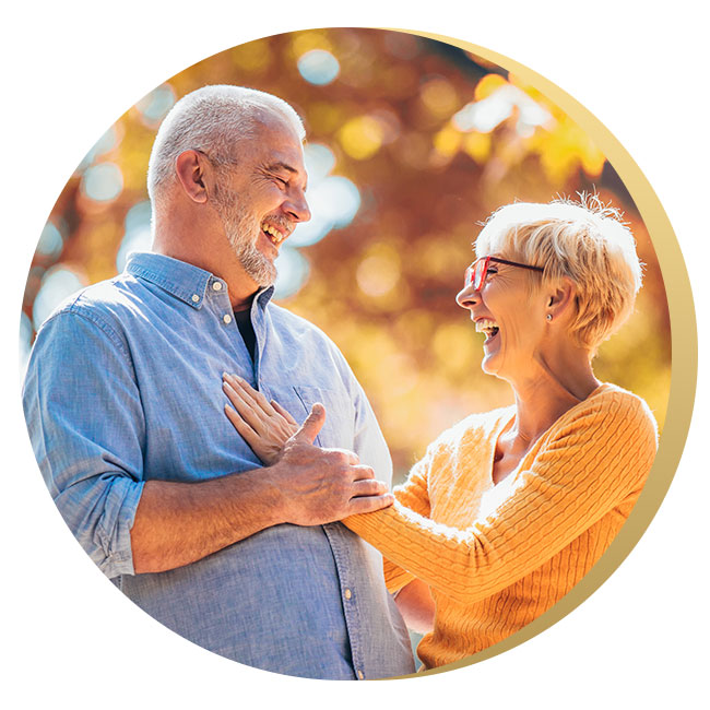 Older couple hugging and laughing, meant to represent the joy that is possible after participating with Susan in solution focused therapy services.