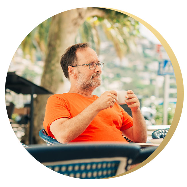 counseling-for-depression-testimonial-2 Older man sitting on a porch with coffee, looking off into the distance. He appears content after presumably engaging with Susan Delia with counseling for depression therapy services in Yakima.