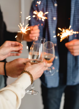 glasses being held up among friends in yakima, washington to celebrate to new year's resolutions